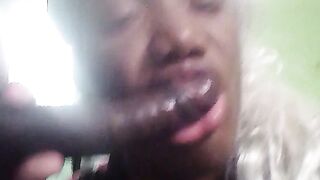 Sucking on a 10inches chocolate dick