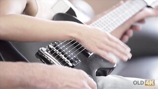 Mature guitarist makes love with skinny brunette on sofa