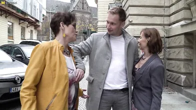 Two naughty mature sluts share one hard younger cock on the couch