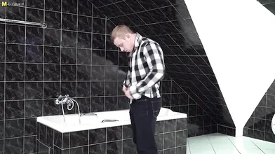 Naughty mature lady catching a toy boy in the bathroom