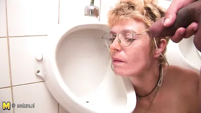 Horny blonde mature slut sucking cock on the toilet