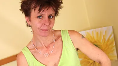 Hairy mature slut masturbating on the bed
