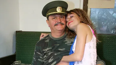 Young girl taking orders from an old sarge