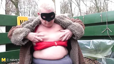 Naughty mature naturist playing outside