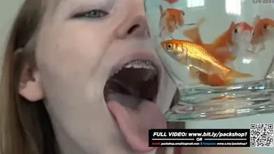 Pretty hungry girl swallows innocent fish - Vore