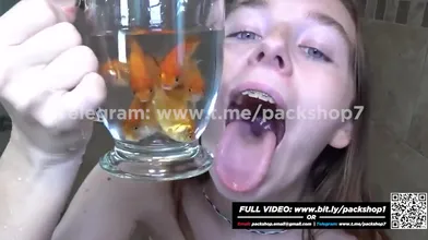 Evil white woman devours live fish in bathroom - vore giantess