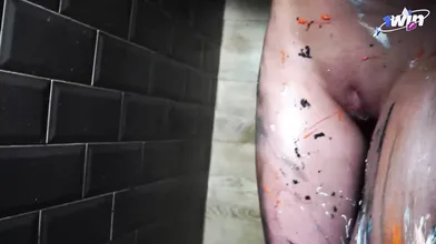 Eva Gold, with immense fake hooters decorated in body paint, lets out an erotic