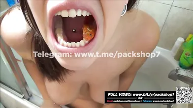 Beautiful and hungry woman devours all her fish in the bathroom
