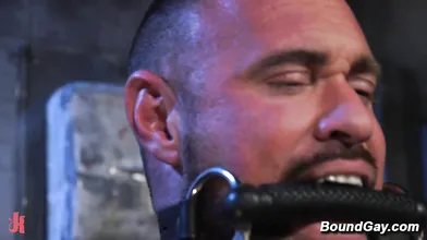 Two doms torment tied up stud