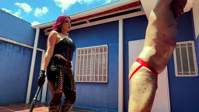 Leather mistress whips her slave with her bullwhip