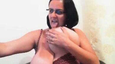 Glasses-wearing MILF reveals her huge breasts on webcam