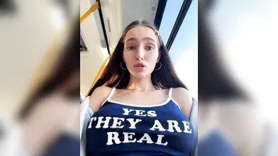 Playful Brunette Teasing with 'Yes They Are Real' Top on Public Transit & Outdoors