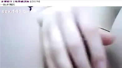 Chinese chick is sucking her lover's cock and fingering her wet pussy to keep herself satisfied